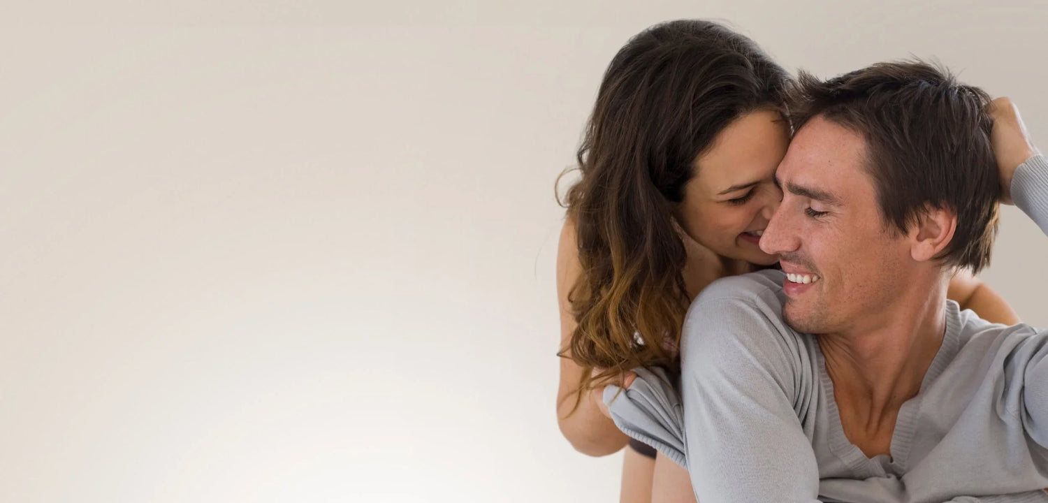 Happy couple embracing, showcasing radiant skin and natural wellness